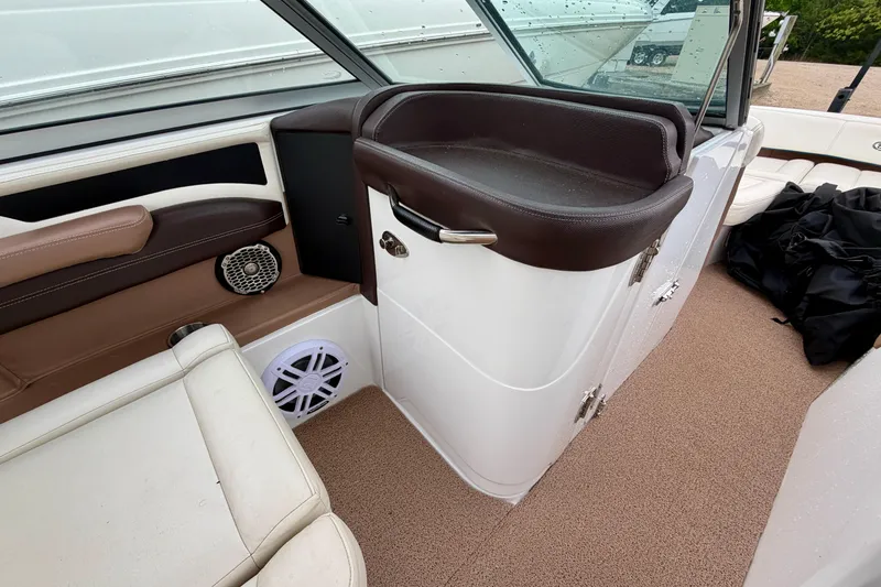 Slide: The Image of Interior of a 2014 Cobalt 24SD WSS boat with brown and white seating. - 15