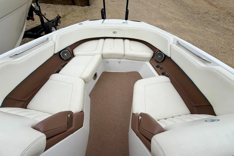 Slide: The Image of 2014 Cobalt 24SD WSS boat interior with white and brown seating. - 18