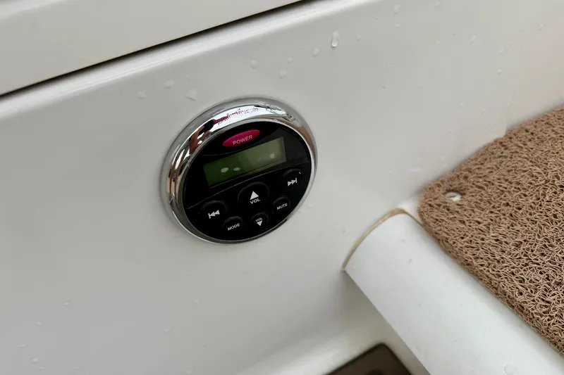 Slide: The Image of Control panel on a 2014 Cobalt 24SD WSS boat, featuring power and volume buttons. - 25