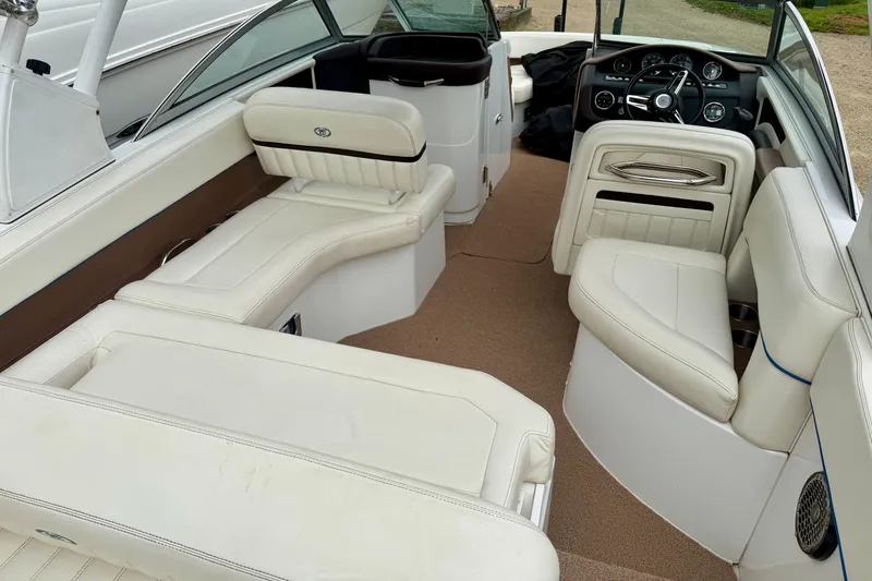 Slide: The Image of 2014 Cobalt 24SD WSS boat interior with white leather seating and modern dashboard. - 26