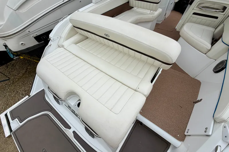 Slide: The Image of 2014 Cobalt 24SD WSS boat interior with white leather seating and brown accents. - 3
