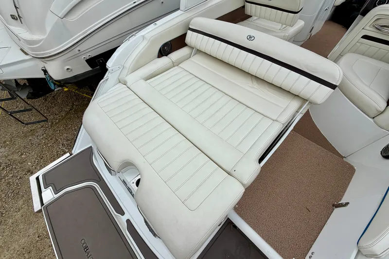 Slide: The Image of 2014 Cobalt 24SD WSS boat with luxurious white seating and spacious deck area. - 4