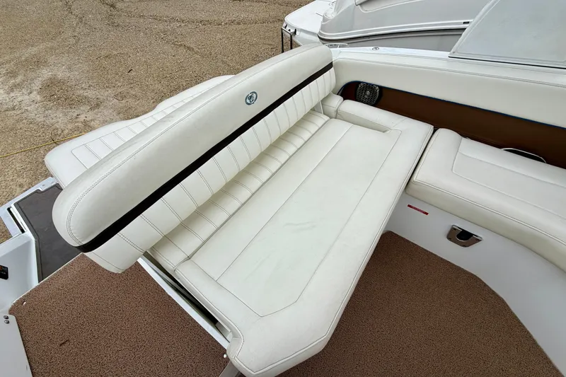 Slide: The Image of 2014 Cobalt 24SD WSS boat interior with white leather seating and brown accents. - 7