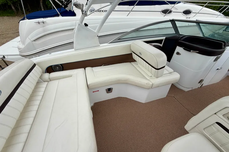 Slide: The Image of Interior of 2014 Cobalt 24SD WSS boat with white leather seating and carpeted floor. - 8