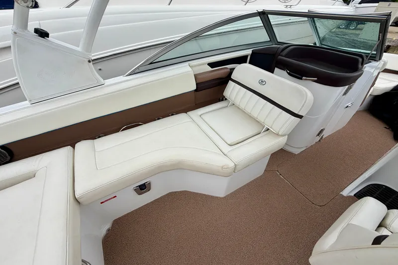 Slide: The Image of 2014 Cobalt 24SD WSS boat interior with white seating and brown accents. - 9