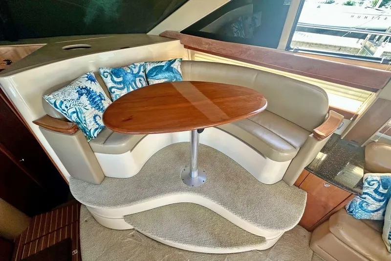 Slide: The Image of Luxurious seating area on 2007 Meridan 391 yacht with elegant wood table. - 11