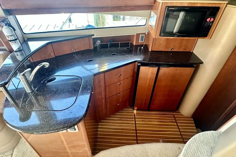 Slide: The Image of Luxurious 2007 Meridan 391 yacht kitchen with sleek countertops and modern appliances. - 12