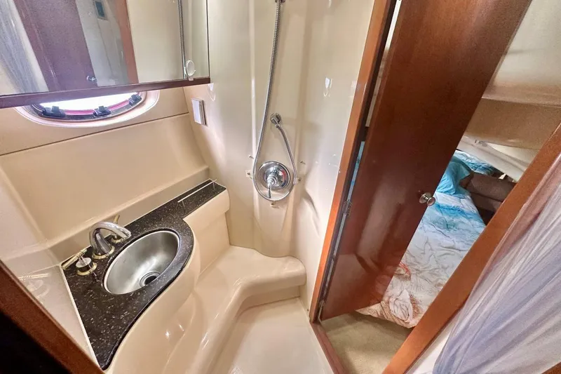 Slide: The Image of Luxurious 2007 Meridan 391 yacht bathroom with sink, shower, and adjoining bedroom. - 15