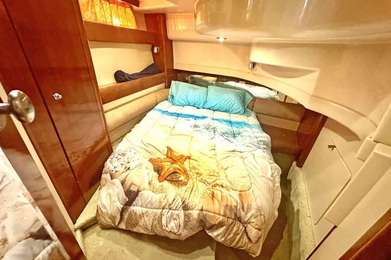 Slide: The Image of Cozy bedroom interior of 2007 Meridan 391 yacht with starfish-themed bedding. - 16