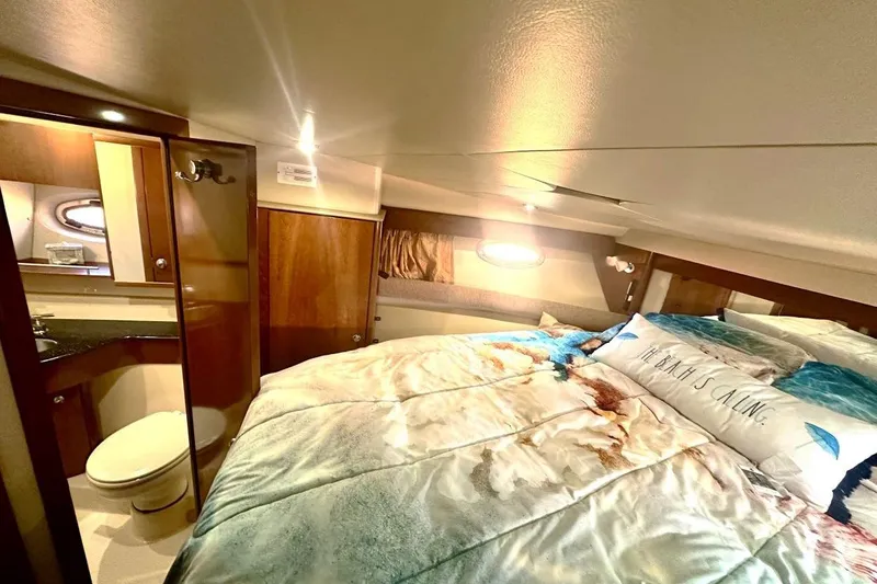 Slide: The Image of Luxurious 2007 Meridan 391 yacht bedroom with cozy bedding and elegant wood finishes. - 17