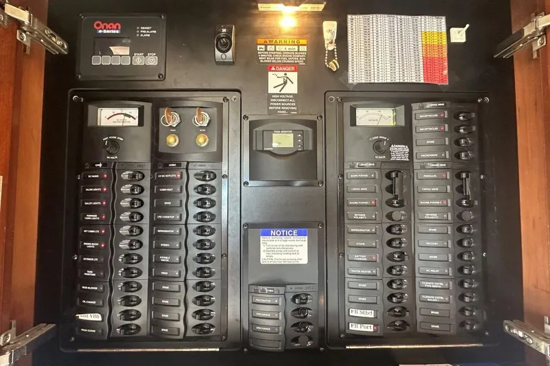 Slide: The Image of Electrical control panel in a 2007 Meridan 391 boat, featuring switches and gauges. - 21