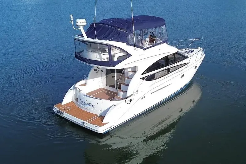 Slide: The Image of 2007 Meridan 391 yacht on calm water, featuring a sleek design and spacious deck. - 4