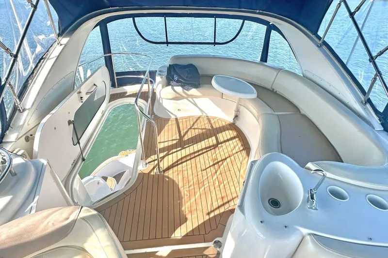 Slide: The Image of Luxurious 2007 Meridan 391 yacht interior with seating, table, and sink, overlooking serene water. - 8