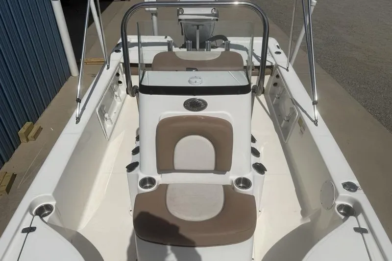 Slide: The Image of 2021 Sea Born FX21 Bay boat interior with beige seating and console. - 16