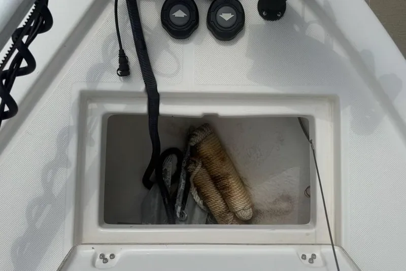 Slide: The Image of Storage compartment of a 2021 Sea Born FX21 Bay boat with fishing gear inside. - 17