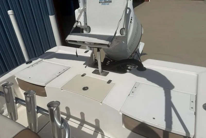 Slide: The Image of 2021 Sea Born FX21 Bay boat with Suzuki outboard motor, docked near a blue building. - 22