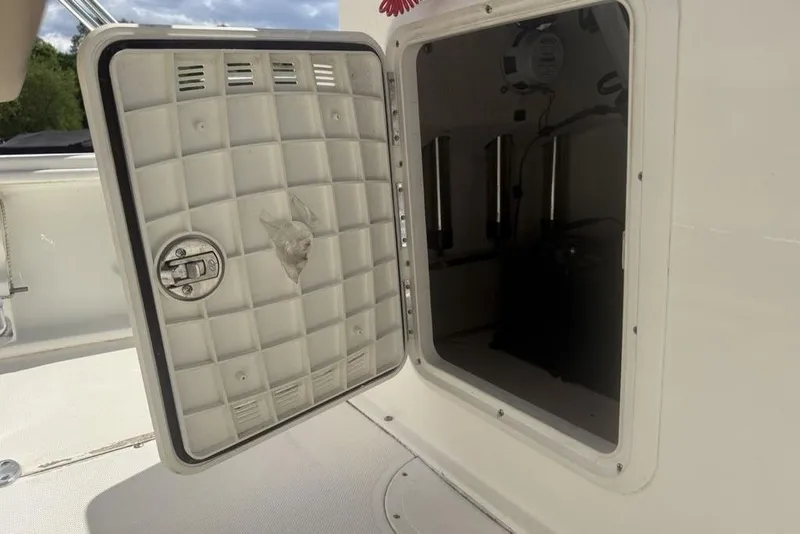 Slide: The Image of Open storage compartment on a 2021 Sea Born FX21 Bay boat. - 24