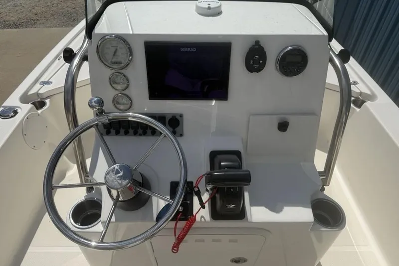 Slide: The Image of 2021 Sea Born FX21 Bay boat console with steering wheel and navigation controls. - 32