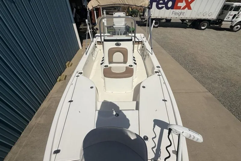 Slide: The Image of 2021 Sea Born FX21 Bay boat, white interior, parked near FedEx truck. - 33