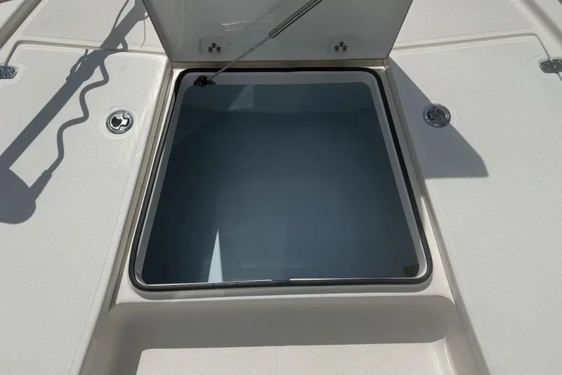 Slide: The Image of Open storage compartment on 2021 Sea Born FX21 Bay boat deck. - 9