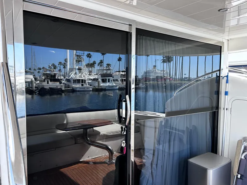 Slide: The Image of 2006 Viking Princess 61 Flybridge yacht with marina view through glass doors. - 10