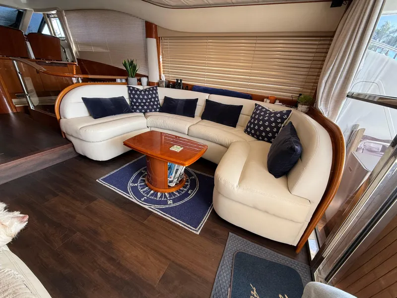 Slide: The Image of Luxurious interior of 2006 Viking Princess 61 Flybridge yacht with elegant seating and wooden accents. - 12