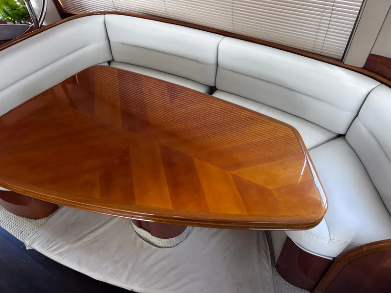 Slide: The Image of Luxurious interior of 2006 Viking Princess 61 Flybridge with elegant wood table and plush seating. - 18