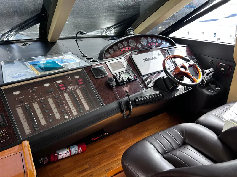 Slide: The Image of 2006 Viking Princess 61 Flybridge helm with navigation controls and leather seating. - 22