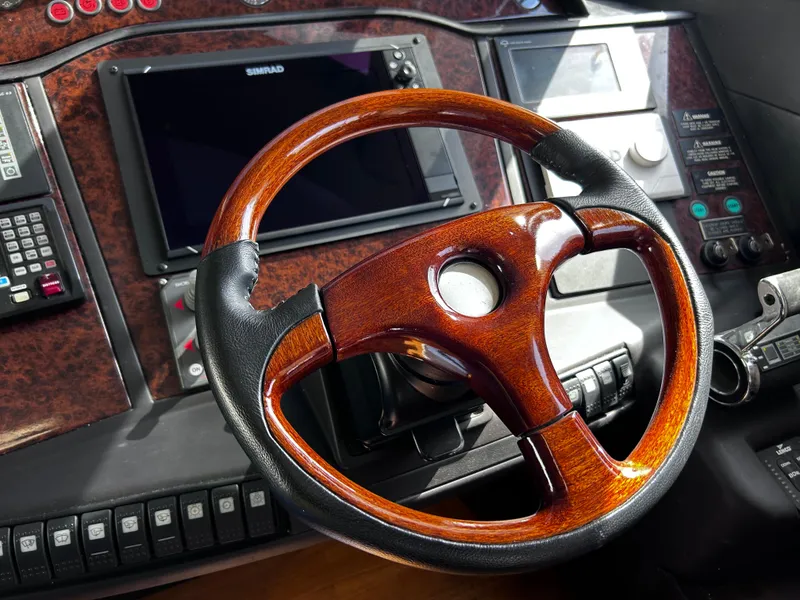 Slide: The Image of Luxurious 2006 Viking Princess 61 Flybridge helm with wood and leather steering wheel. - 23