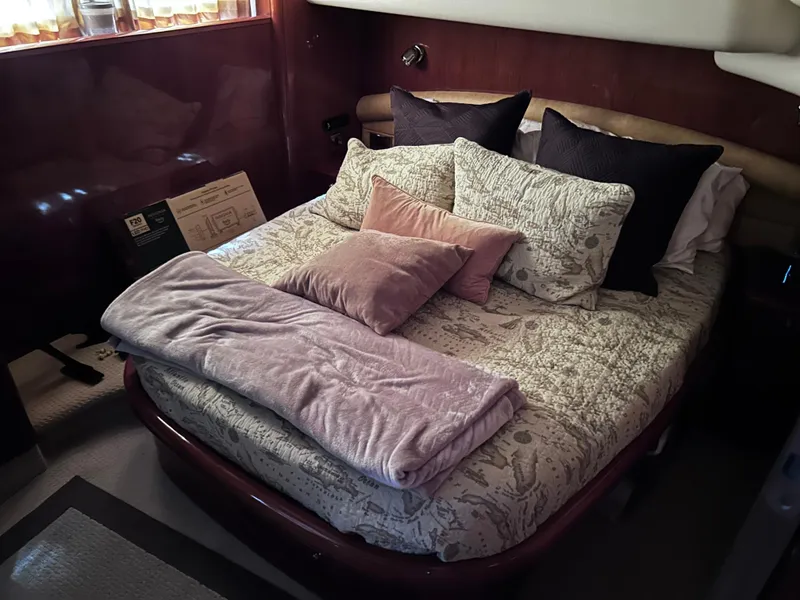 Slide: The Image of Luxurious bedroom interior of 2006 Viking Princess 61 Flybridge yacht with plush bedding. - 26
