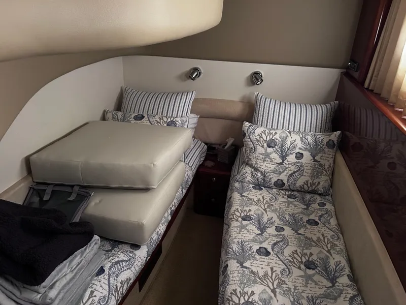 Slide: The Image of Twin cabin interior of 2006 Viking Princess 61 Flybridge yacht with patterned bedding. - 27