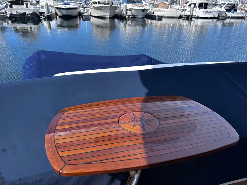 Slide: The Image of Viking Princess 61 Flybridge 2006 yacht with wooden table, docked at marina. - 7