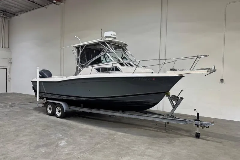 The Image of 1997 Grady-White Seafarer 228 boat on trailer in warehouse setting. - 0