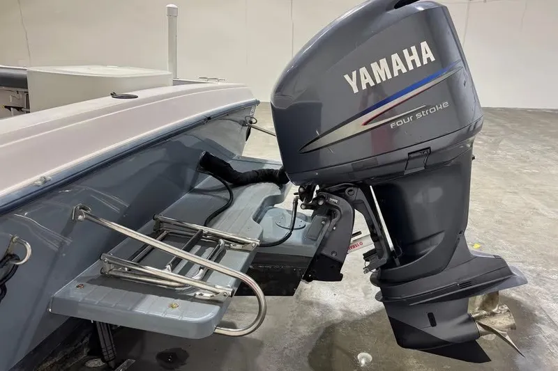 Slide: The Image of 1997 Grady-White Seafarer 228 boat interior with rod holders and covered console. - 10