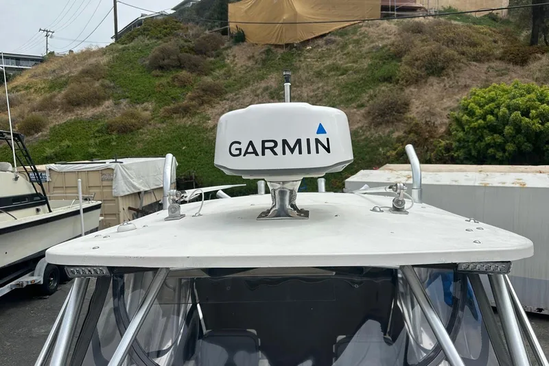 Slide: The Image of 1997 Grady-White Seafarer 228 with Garmin radar, docked outdoors. - 19