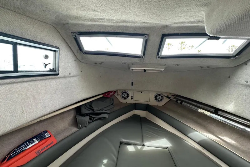 Slide: The Image of Interior cabin of a 1997 Grady-White Seafarer 228 boat with windows and seating. - 22
