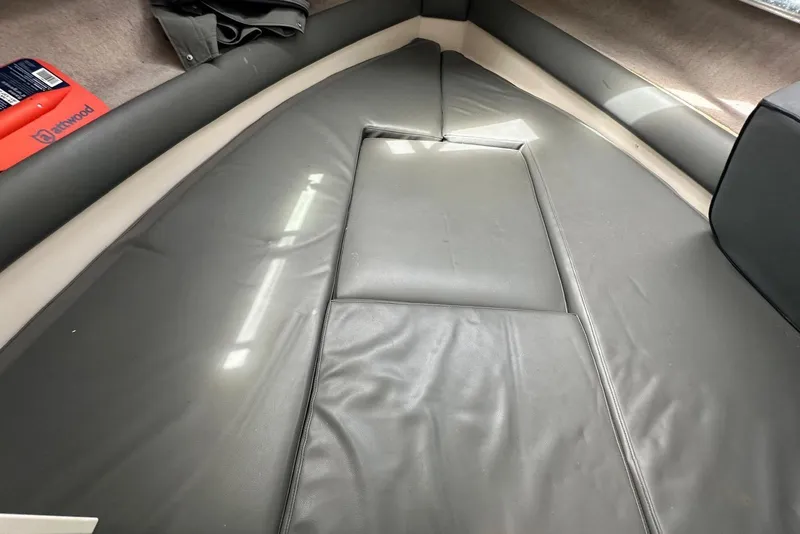 Slide: The Image of Interior cabin of a 1997 Grady-White Seafarer 228 boat with cushioned seating. - 23