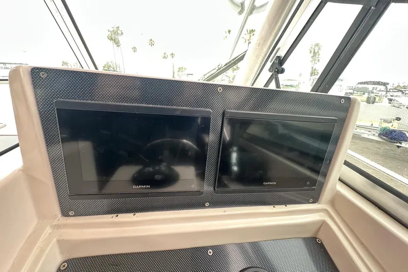 Slide: The Image of Dashboard of a 1997 Grady-White Seafarer 228 with dual Garmin displays. - 26