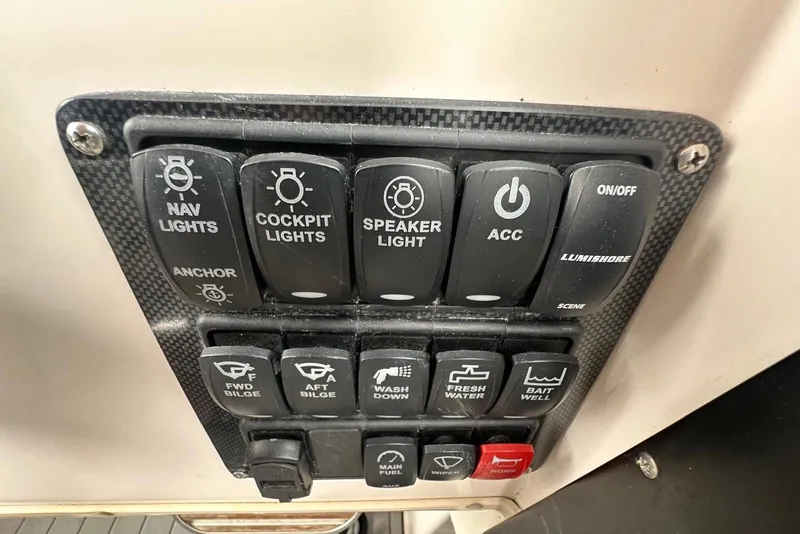 Slide: The Image of Control panel of a 1997 Grady-White Seafarer 228 boat with various switches. - 32