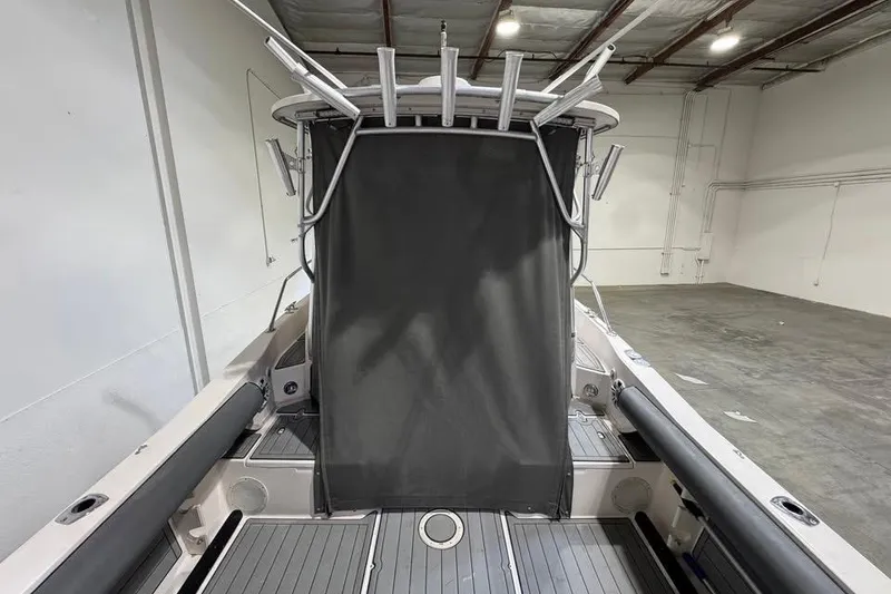 Slide: The Image of 1997 Grady-White Seafarer 228 boat interior with rod holders and covered console. - 7