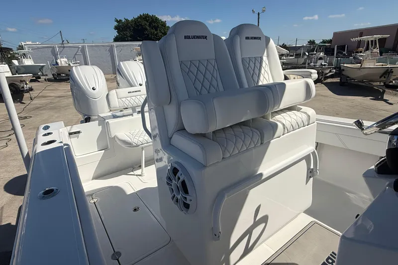Slide: The Image of 2025 Bluewater 25t boat with dual engines and luxurious seating in a marina setting. - 11