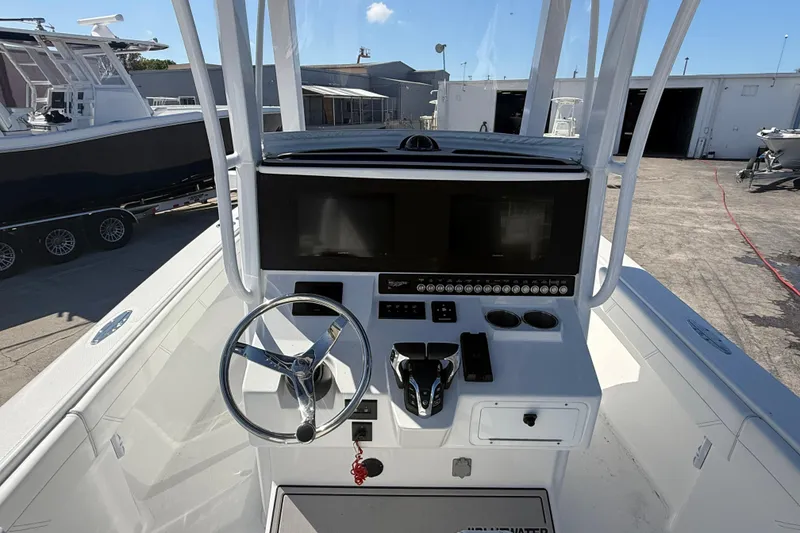 Slide: The Image of 2025 Bluewater 25t boat cockpit with steering wheel and control panel. - 14