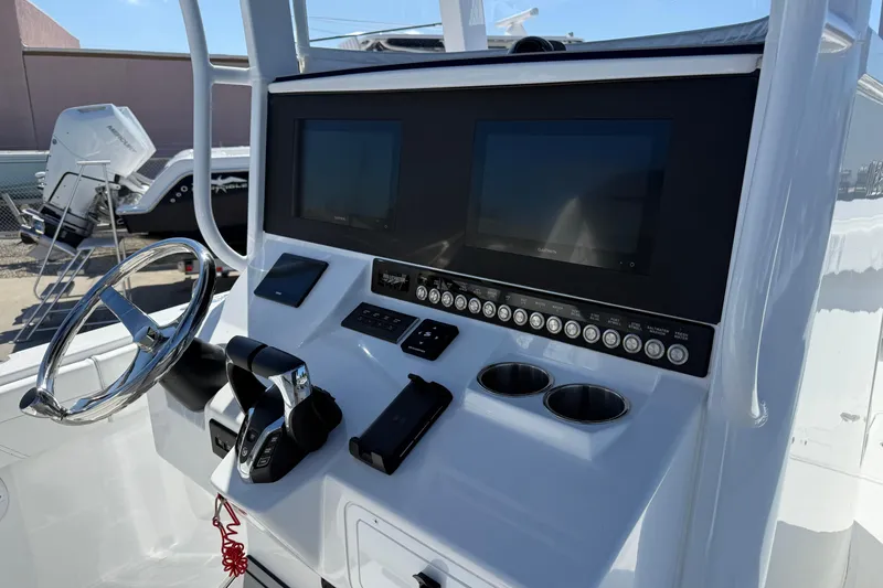 Slide: The Image of Helm of 2025 Bluewater 25t boat with dual screens and controls. - 16