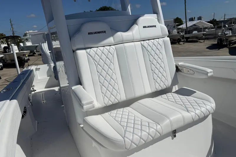 Slide: The Image of Luxury seating on 2025 Bluewater 25t boat, featuring white quilted upholstery. - 18