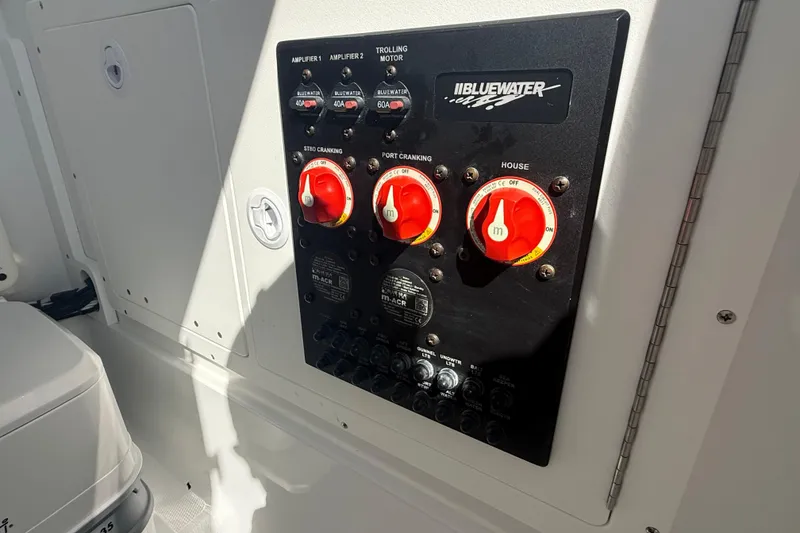 Slide: The Image of Control panel of a 2025 Bluewater 25t boat with switches and dials. - 26