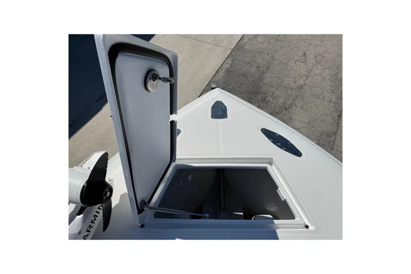 Slide: The Image of Open hatch on 2025 Bluewater 25t boat deck, showing storage compartment. - 27