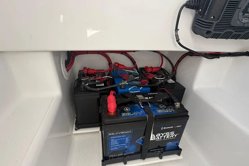 Slide: The Image of Battery compartment of a 2025 Bluewater 25t boat, featuring Abyss batteries and wiring. - 28