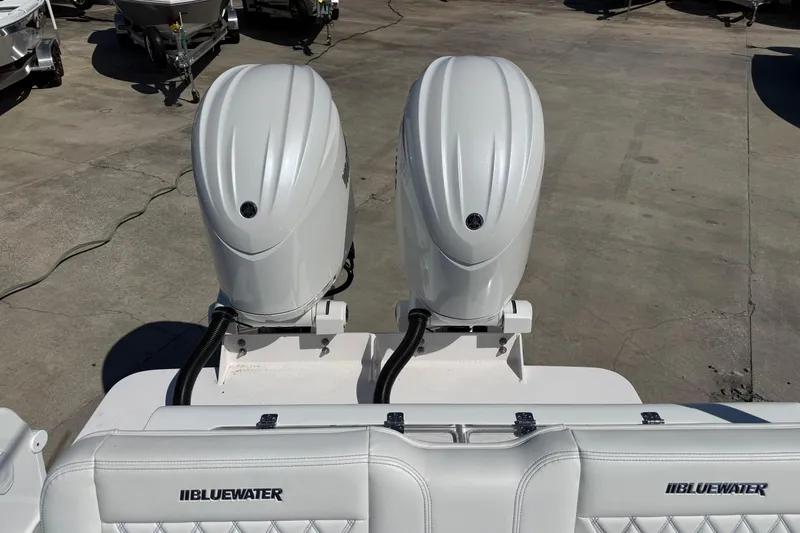 Slide: The Image of Twin outboard engines on a 2025 Bluewater 25t boat, docked on concrete. - 31