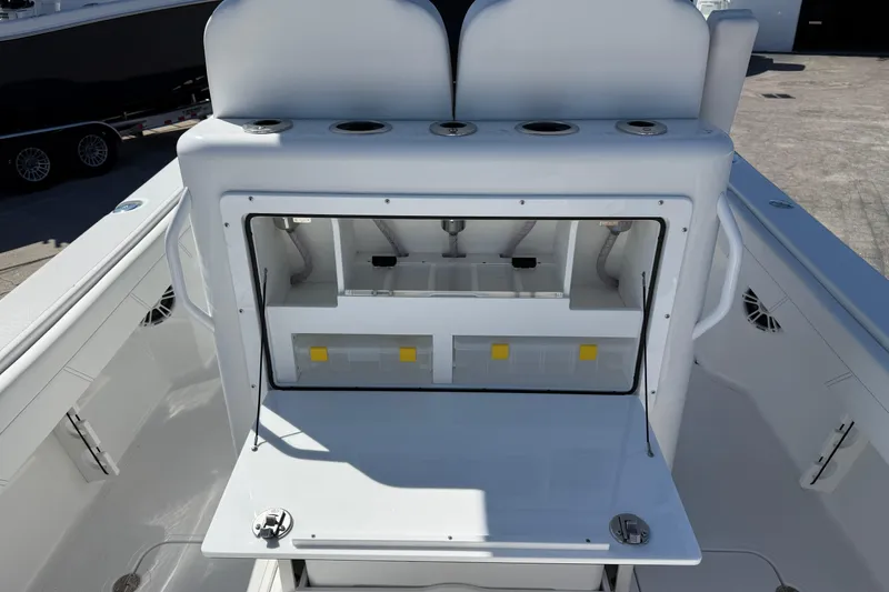 Slide: The Image of 2025 Bluewater 25t boat interior with open storage compartment and rod holders. - 32