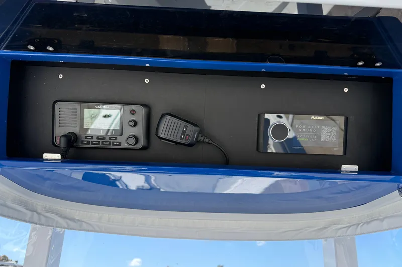 Slide: The Image of Control panel of a 2025 Bluewater 25t boat featuring Garmin and Fusion devices. - 34